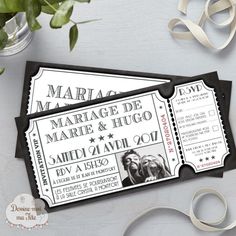 two black and white tickets sitting on top of a table