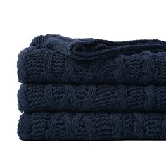 three dark blue towels stacked on top of each other