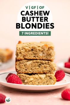 three pieces of cashew butter blondies stacked on top of each other with raspberries