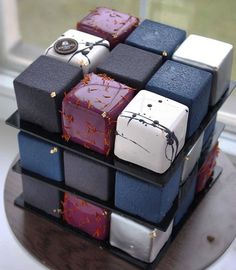 a cake made to look like some sort of cube with different colored blocks on it