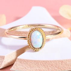 "Here is Oval Opal Gold Halo Wedding Ring for Bride, You can use it as a 14K Custom Birthstone Multicolor Art Deco Band. Our 18K Personal Gemstone Jewelry is use as Mystical Gifted Hers Ring. This oval gemston ring looks like dainty mystical ring. Personal jewelry lab opal ring band will be perfect gift for mothers birthday. Dainty halo wedding band can be customized with your Mom's Birthstone Ring. We can turns it into a art deco engage ring. Our 10K comfortable fitting ring is great multicolor Gold Opal Ring With Halo Design - Gift, Stamped 14k Oval Opal Wedding Ring, White Hallmarked Birthstone Wedding Ring, 14k Gold Opal Ring With Accent Stones, Gold Opal Ring With Accent Stones In 14k Gold, Oval Opal Wedding Ring, Gold Opal Wedding Ring Stamped 14k, Gold Opal Ring With Halo Design, 14k Stamped Opal Promise Ring