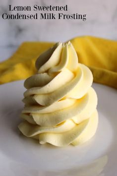 a white plate topped with sliced bananas on top of a table next to a yellow napkin