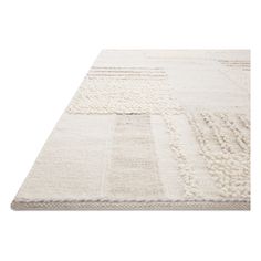 a white rug with different colored squares on it