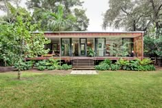 the house is surrounded by trees and plants