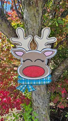 a paper cut out of a reindeer head hanging from a tree