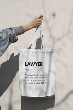 SPECIFICATION: * Tote Bag * 145/220g/m2 * 100% Cotton * Eco Friendly Raw Natural Finish ONE SIZE: * Dimensions: +/- 39x41 cm (15x16 Inches) * Capacity 15 Litres * With Long Handles DESCRIPTION: Introducing our Lawyer Definition Cotton Tote Bag, a must-have accessory for legal professionals and law enthusiasts. Made from high-quality cotton, this tote bag combines style and functionality, making it the perfect companion for everyday use. Crafted with care, our tote bag features a captivating print that showcases the definition of a lawyer. With bold typography and symbolic graphics, it beautifully captures the essence of this esteemed profession. Carry your belongings in style while proudly displaying your passion for the law. Our spacious tote bag offers ample room to hold your essentials, Lawyer Gift Ideas, Lawyer Bag, Law School Preparation, Law School Life, Law School Inspiration, My Future Job, Lawyer Gifts, Law Student, Bold Typography