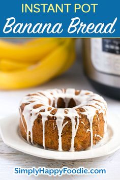 a bundt cake with white icing sitting on a plate next to some bananas