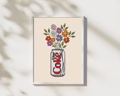 a coke can with flowers in it on a white background