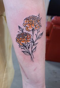 a small flower tattoo on the leg