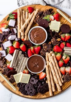 a platter with chocolate, strawberries and crackers on it that says chocolate charcuterie board ideas