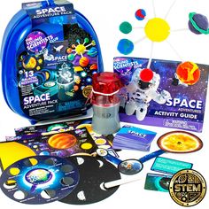 an assortment of science kits and books on a white background, including a space project