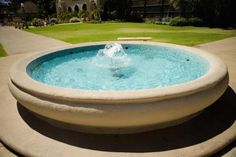 a water fountain in the middle of a driveway