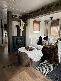 a living room filled with furniture and a fire place in the middle of the room