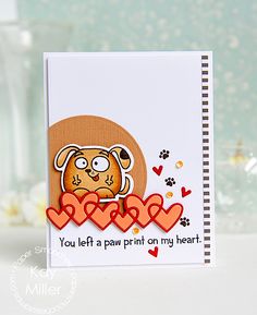 a close up of a card with a dog on it and hearts in the background