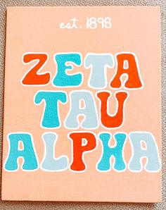 a book with the words zeta tau alphi written in blue and orange on it