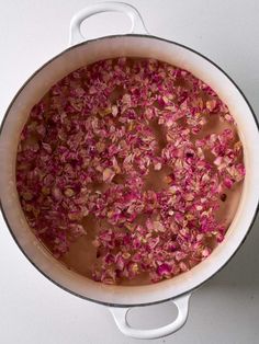 a pot filled with pink flowers on top of a table