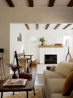 a living room filled with furniture and a fire place