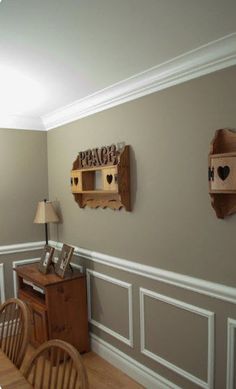 a dining room with two wooden shelves on the wall