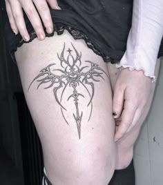 a woman with a tattoo on her thigh