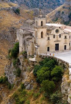 an old church perched on the side of a cliff