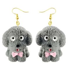 a pair of earrings with a dog wearing a pink bow tie