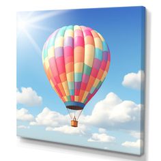 a hot air balloon floating in the sky with clouds behind it and sun shining on top