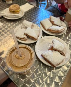 several desserts are on plates and one is covered in powdered sugar