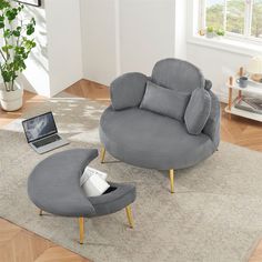 a living room with a laptop and chair