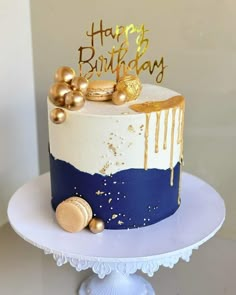 a birthday cake decorated with gold and blue icing