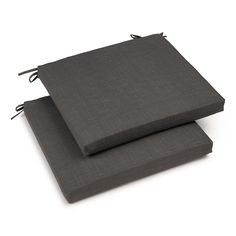 two gray cushions sitting on top of each other