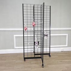 a metal rack with several stuffed animals on it's sides and two shelves in the middle