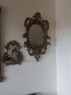 there is a mirror on the wall next to two mirrors