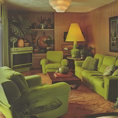 a living room filled with green furniture and a yellow lamp on top of a table