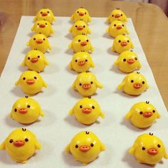 there are many little yellow chicks on the table together, all lined up and ready to be eaten