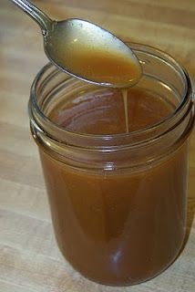 a spoon in a jar filled with brown liquid