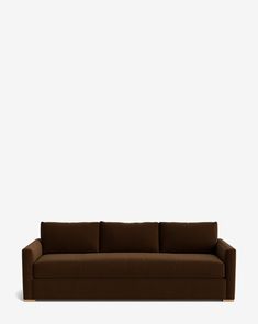 a brown couch against a white wall