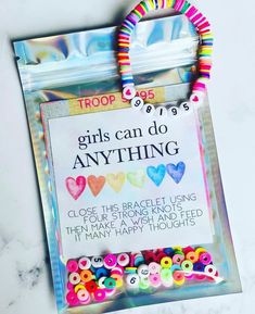 there is a bag with some beads on it and a sign that says girls can do anything