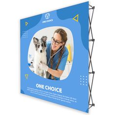 a woman is petting a small dog on the side of a blue wall banner