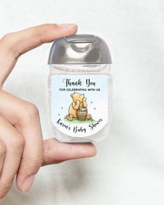 a hand holding a small jar with a bear on it's lid and thank you for celebrating with us