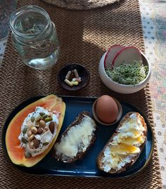 a plate with bread, eggs and vegetables on it