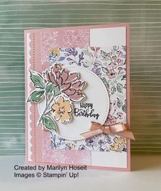 a close up of a birthday card with flowers on the front and bottom, along with a pink ribbon