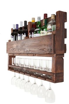 a wooden shelf with wine glasses and liquor bottles on the top, hanging from it's side