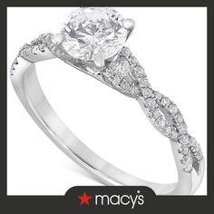 a white gold ring with an oval cut diamond in the center and two rows of diamonds on