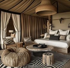 a bed room with a neatly made bed next to a zebra rug and two chairs