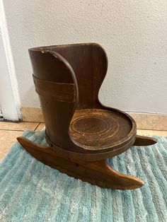 an old wooden rocking chair on a blue rug