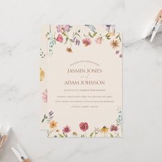 a wedding card with watercolor flowers on it