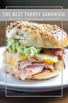 the best turkey sandwich with avocado, ham and cheese on a bagel bun