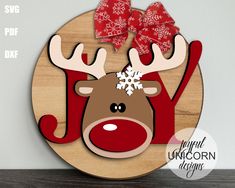 a wooden sign with a reindeer wearing a red bow