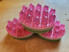 three bowls filled with watermelon seeds on top of a wooden table next to each other