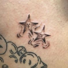 a star tattoo on the back of a woman's shoulder